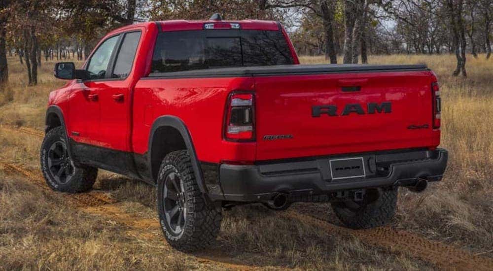 A red 2022 Ram 1500 is shown from the rear at an angle after leaving a Winchester Ram dealer.