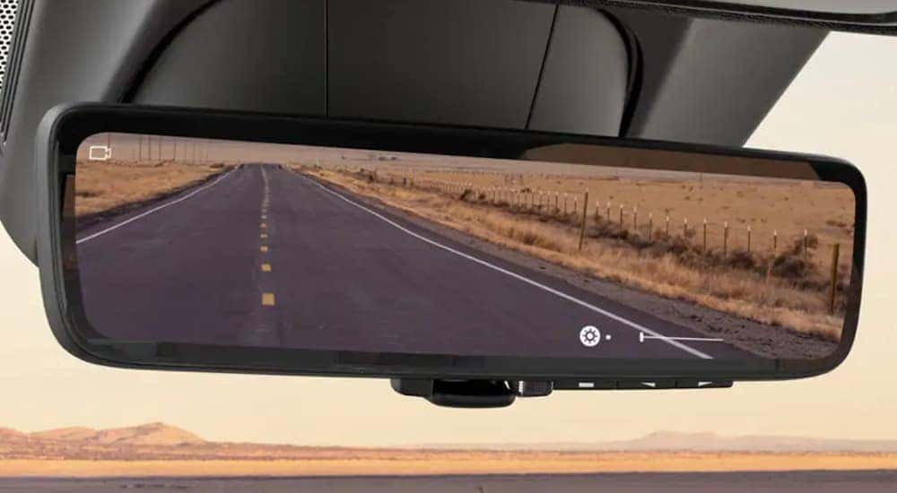 A close up shows a rear view mirror in a 2021 Ram 1500 after leaving a used car dealer in Lexington.