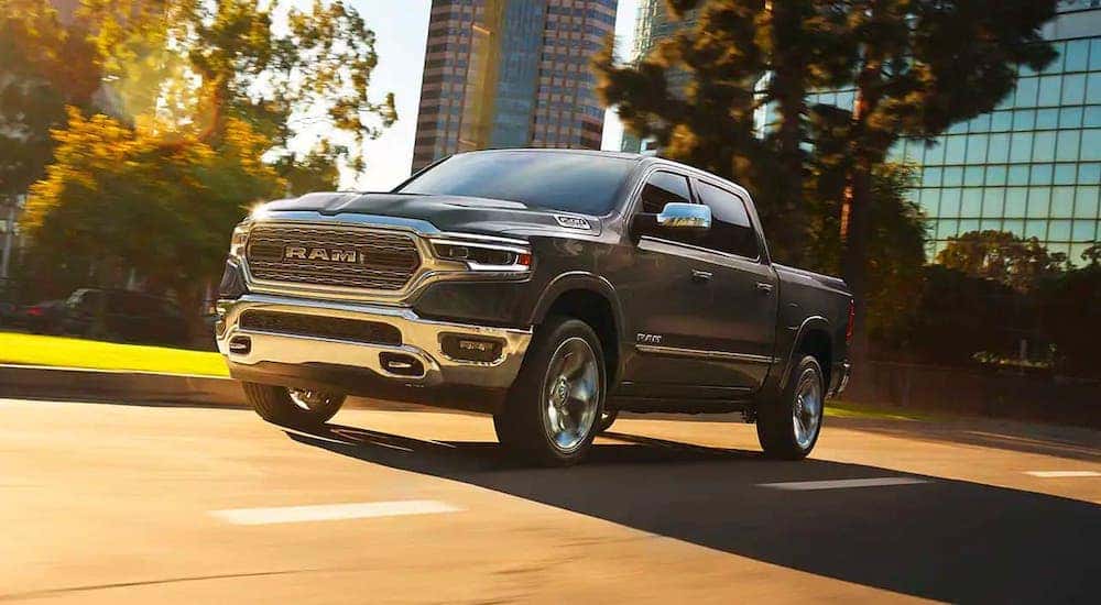 A black 2018 Ram 1500 is driving on a street near Lexington, KY.