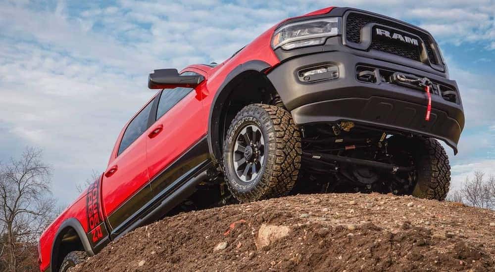 A red 2021 Ram 2500 Power Wagon is shown from a low angle parked on a large rock formation.