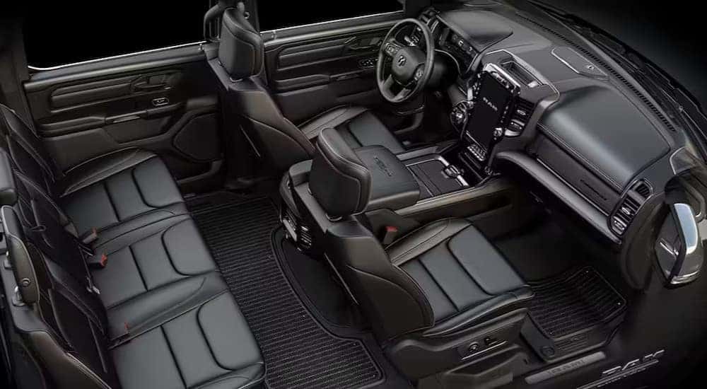 The black interior, dash and cargo spaces in a 2024 Ram 1500 for sale.