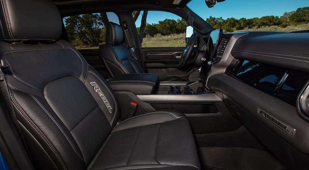 The black interior and front seating of a 2025 Ram 1500 Rebel.