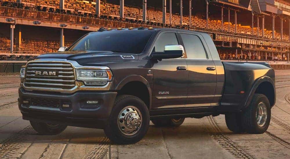 A black 2020 Ram 3500 Mega Cab is parked in a stadium, angled left.