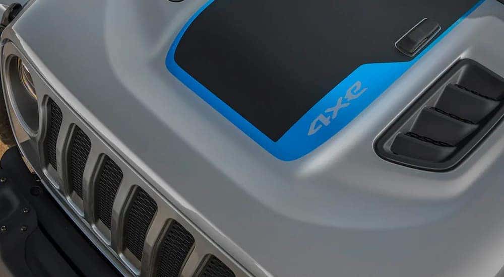 A close up shows the hood and badging from a high angle on a silver 2021 Jeep Wrangler 4xe.