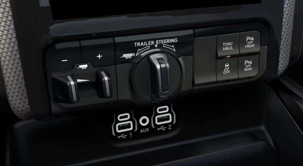Trailer Steering knob and buttons are shown on a dash of a 2024 Ram 2500.