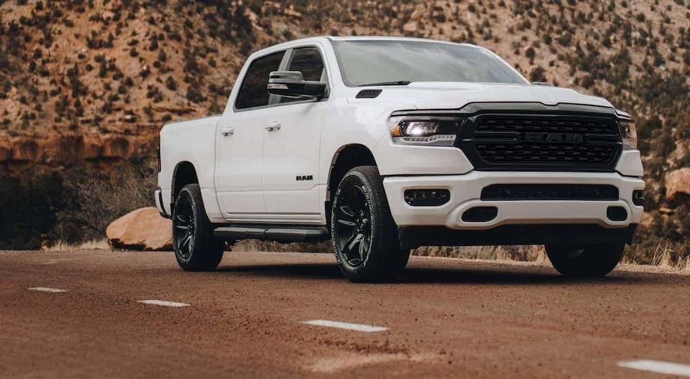 A white 2023 Ram 1500 is shown from the front at an angle.