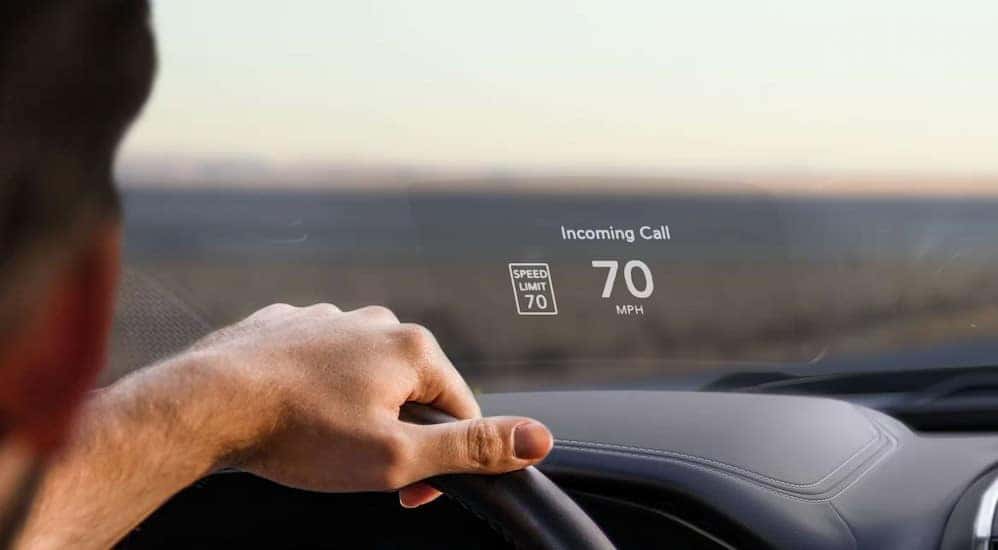 The speed limit, an incoming call and vehicle speed is shown on the interior windshield of a 2024 Ram 1500 Big Horn.