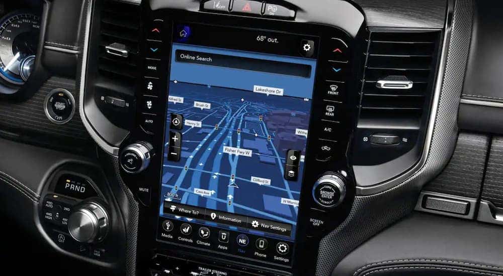 A close up shows the infotainment screen with navigation in a 2021 Ram 1500.