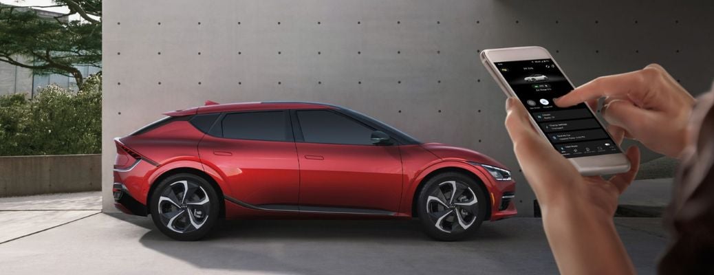 a hand using phone to connect to the 2024 Kia EV6