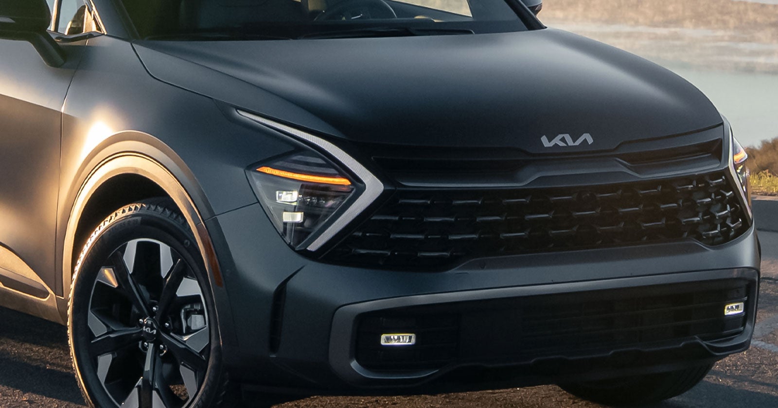 Black Kia SUV front grille view