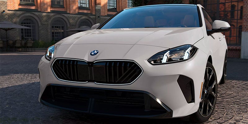 2026 BMW 2 Series Coupe in white, showcasing its sleek front design and black accents.