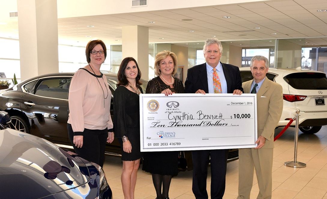 folks holding large check showing money raised