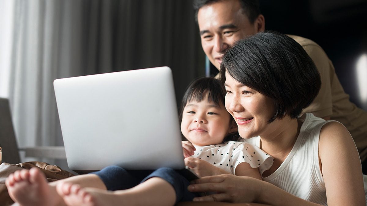 family gathered around a laptop