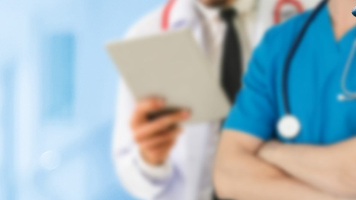 nurse and doctor holding an ipad