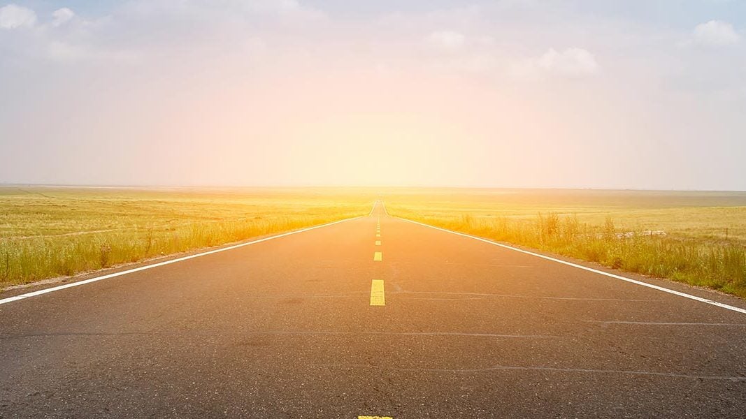 road heading directly into the sun