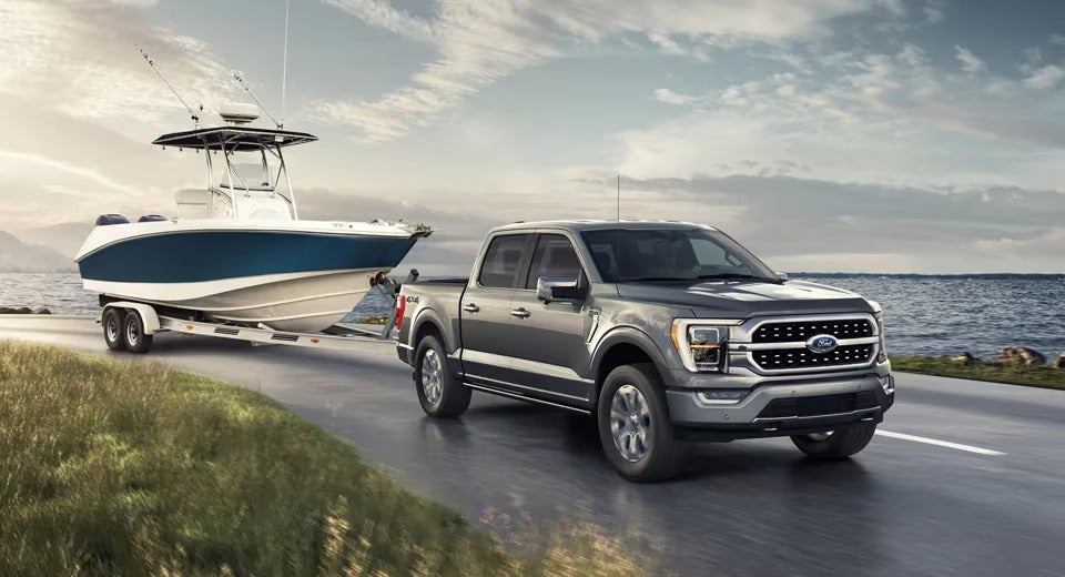 ford F-150 pulling a boat along the coast of the ocean