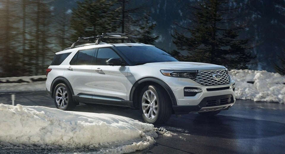 white Ford Explorer driving on sunny winter day