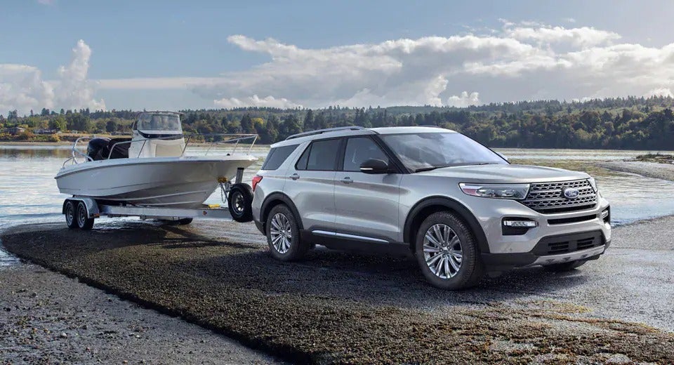 silver Ford Explorer launching boat into body of water