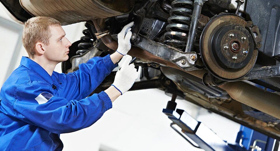 technician looking at suspension