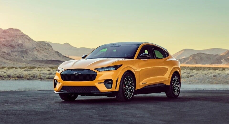 side view of a yellow Mustang-E GT parked in front of a desert