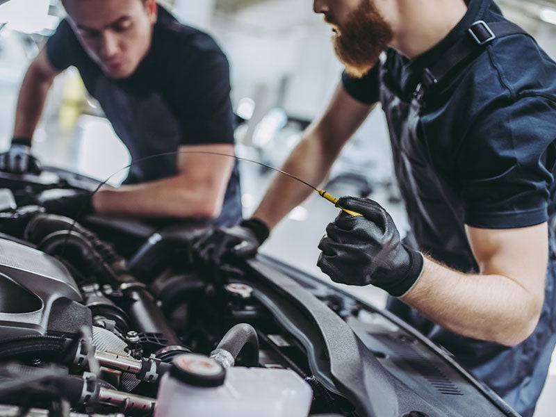 two service technician working on a vehicle engine