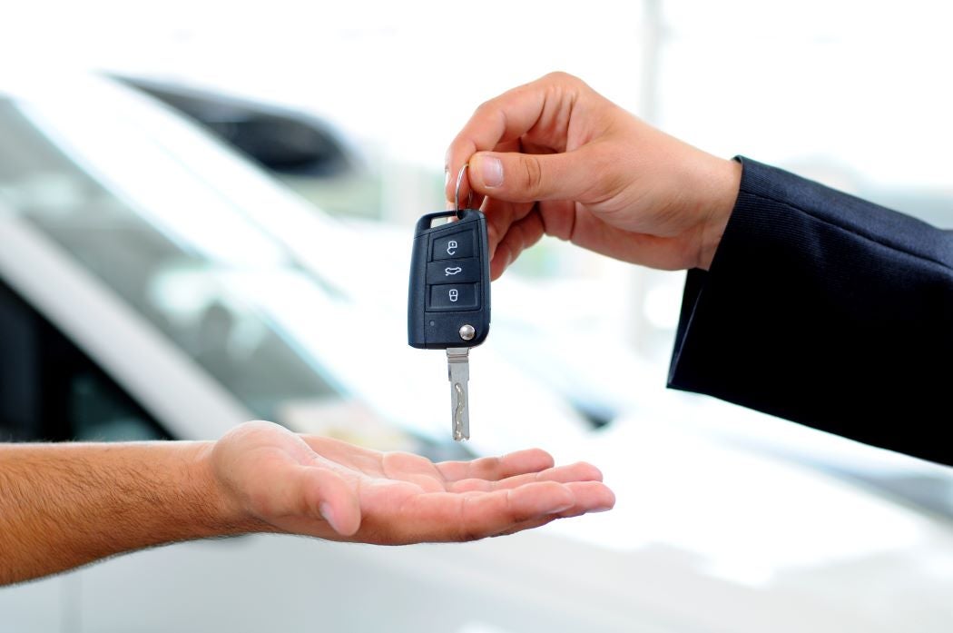 A person carries car keys from their trade in car