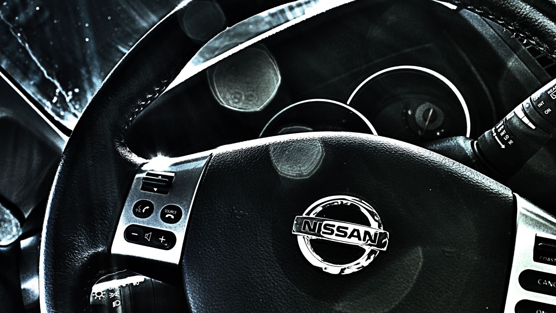 The steering wheel of a Nissan car