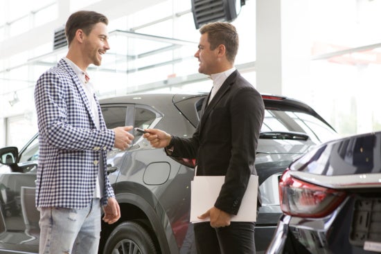 Customer getting the car keys at the dealership