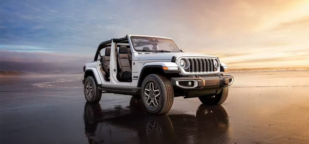 white jeep wrangler on the beach