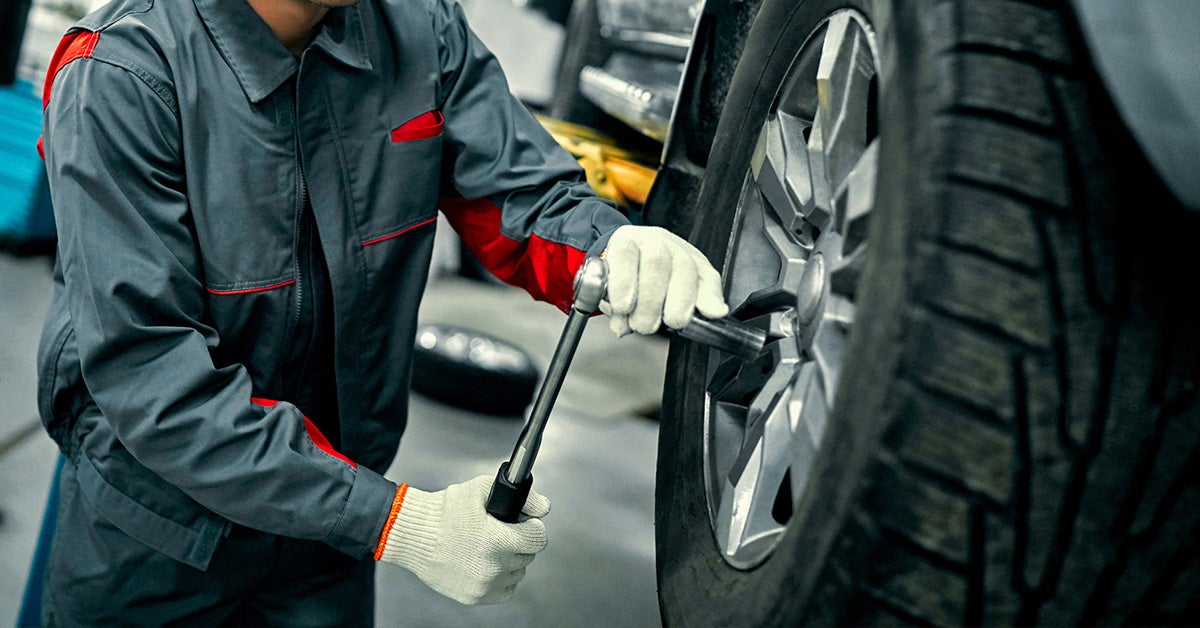 Jeep service technician removing wheel