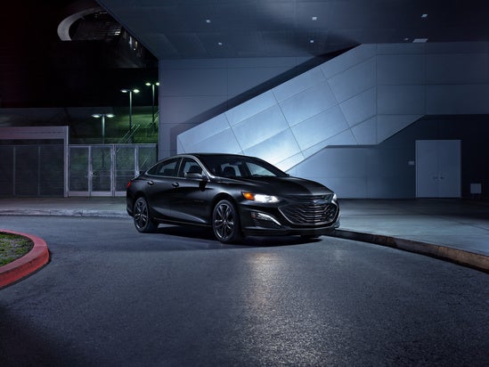 a Chevrolet parked at night with headlights on