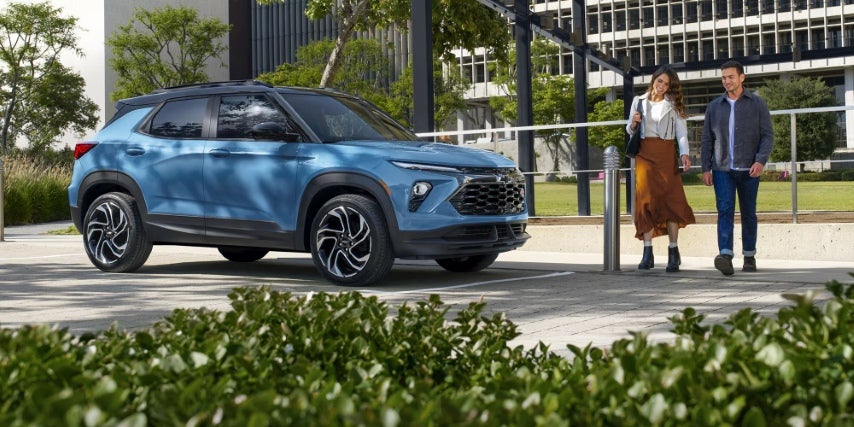 Couple walking to new car they bought.