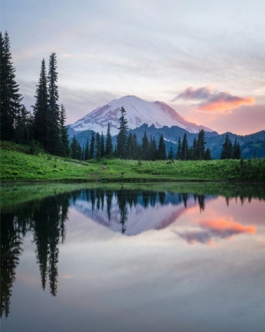 Beautiful, still, lake with a mountain in the background.
