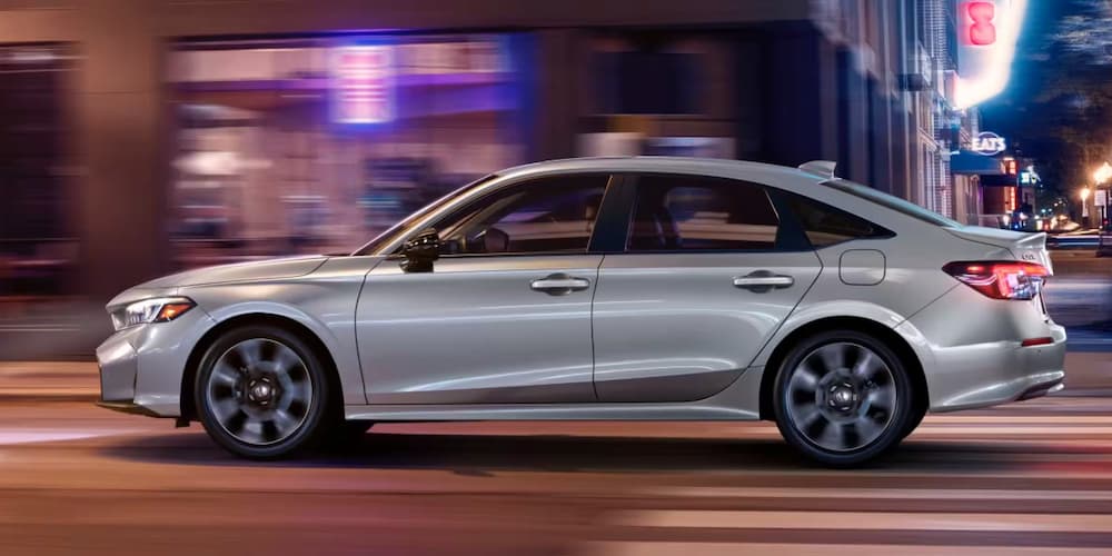 Silver 2026 Honda Civic for sale on a test drive through a city