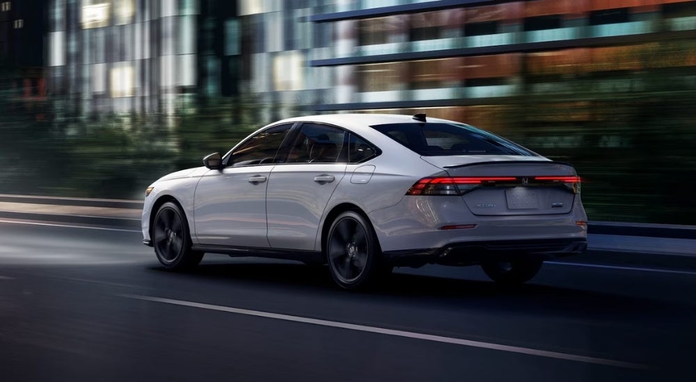 A white 2025 Honda Accord driving in a city