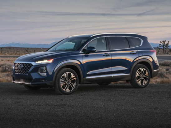 dark blue Hyundai SUV parked at dusk in the desert
