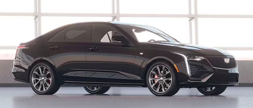 black Cadillac CT4 parked inside a showroom