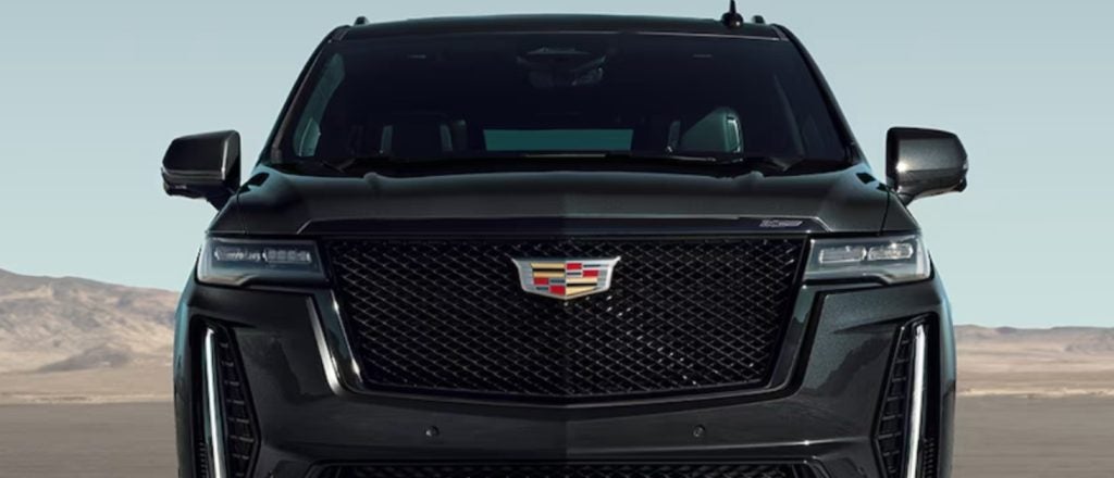 close up of a black Cadillac Escalade grilled in a desert