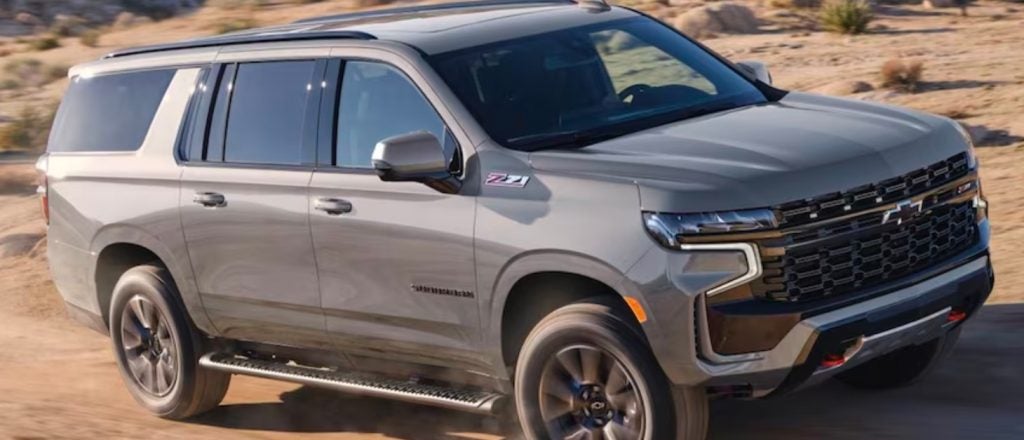 gray Chevrolet Suburban driving off road in the desert