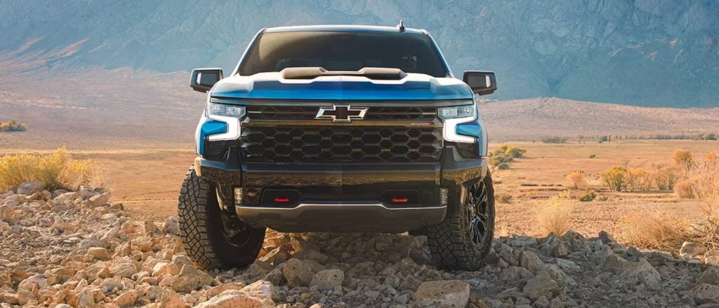 blue Chevrolet Silverado parked off road in the desert