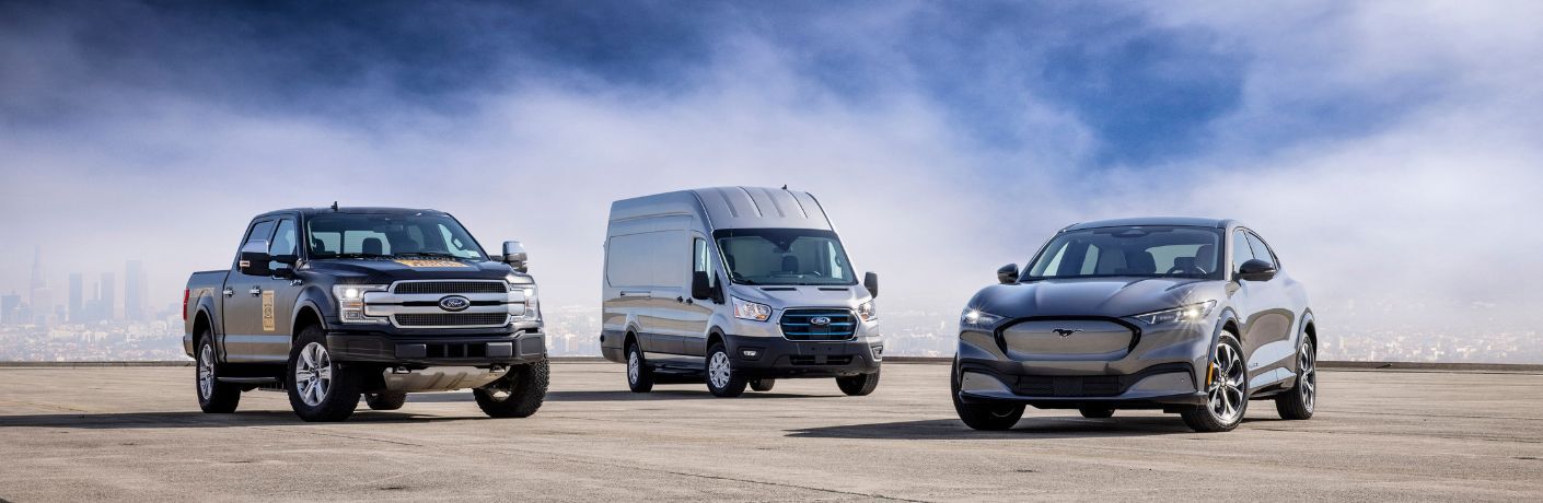 Three Ford vehicles with a cityscape in the background