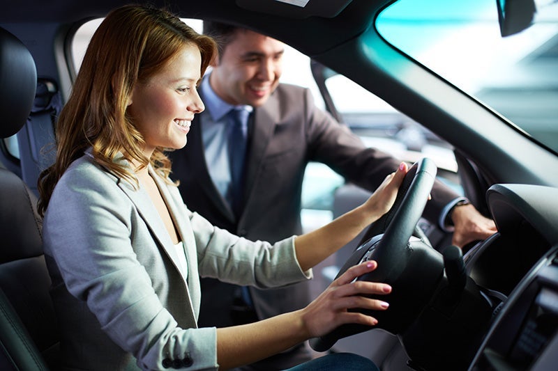 Salesperson and women with car.