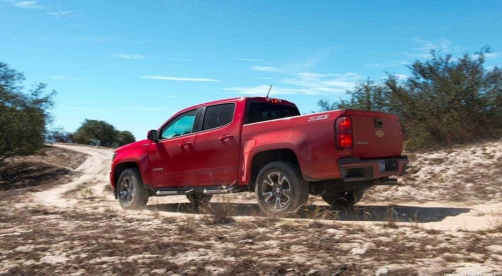A red 2017 Chevy Colorado Z71 is shown on a dirt path.
