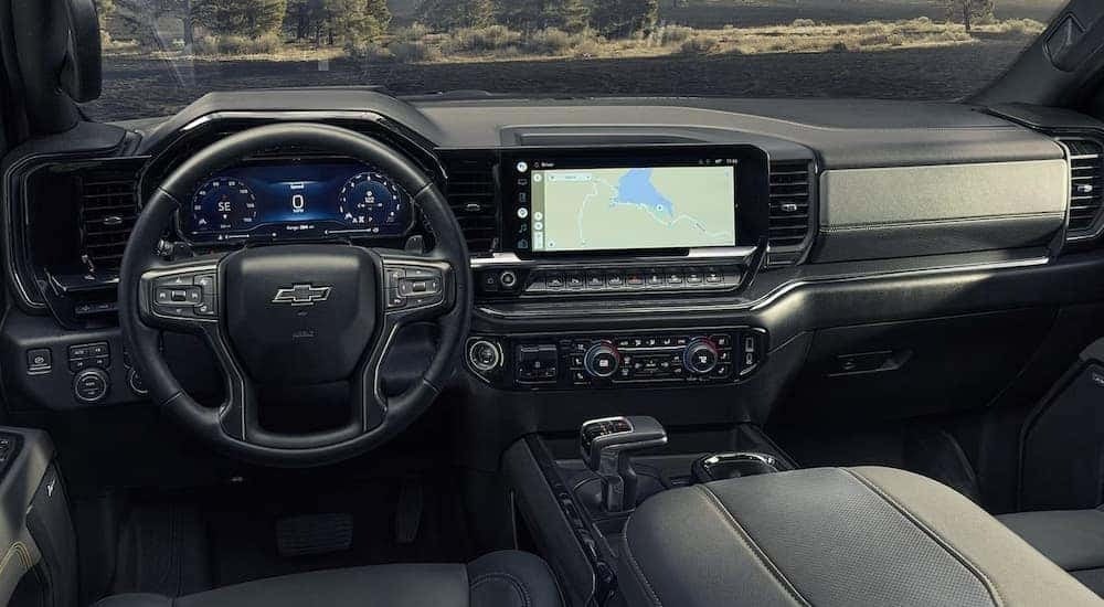 The front seats and dashboard in a 2024 Chevy Silverado 1500 High Country.