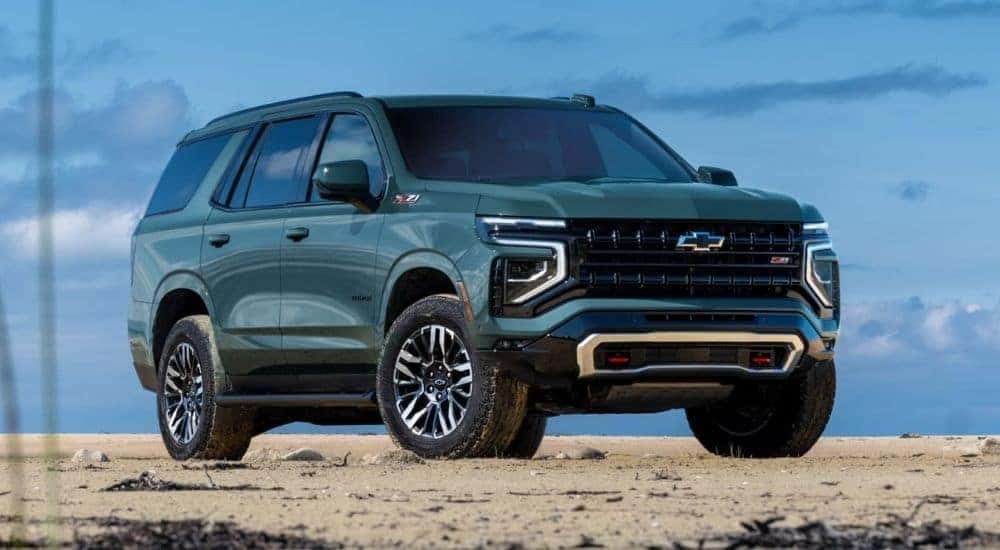 A green 2025 Chevy Tahoe Z71 is shown on a cloudy day