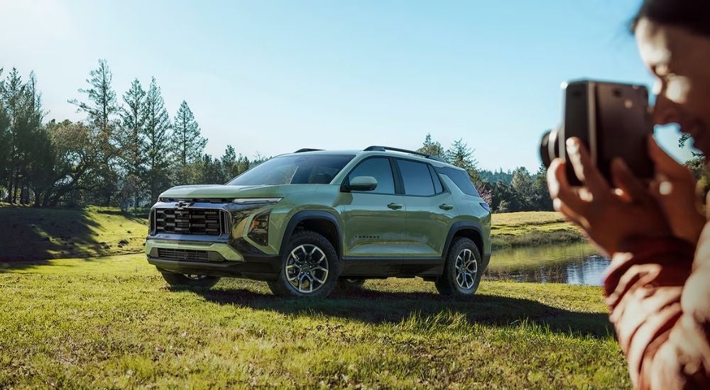 Green 2026 Chevy Equinox parked on a field