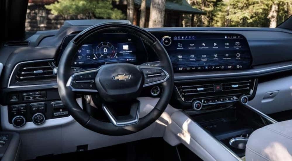 The black and white interior and dash in a 2025 Chevy Suburban is shown.