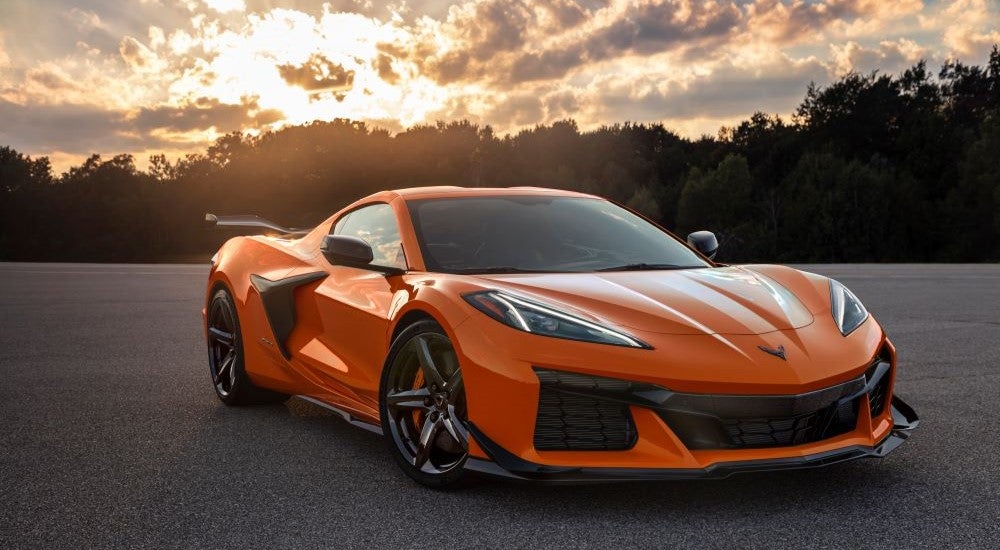 Orange 2023 Chevy Corvette Z06 parked on pavement after leaving a Chevy dealer in Hoover, AL