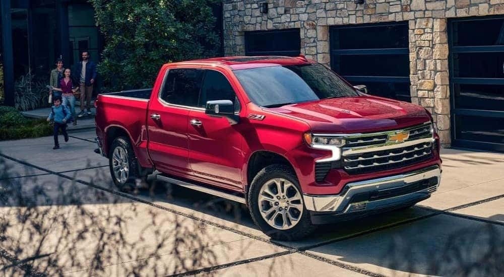 A red 2024 Chevy Silverado 1500 Z71 is shown parked on a driveway.