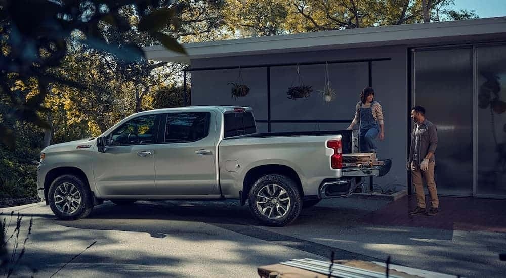 A silver 2023 Chevy Silverado 1500 Z71 is shown from the side parked in a driveway.